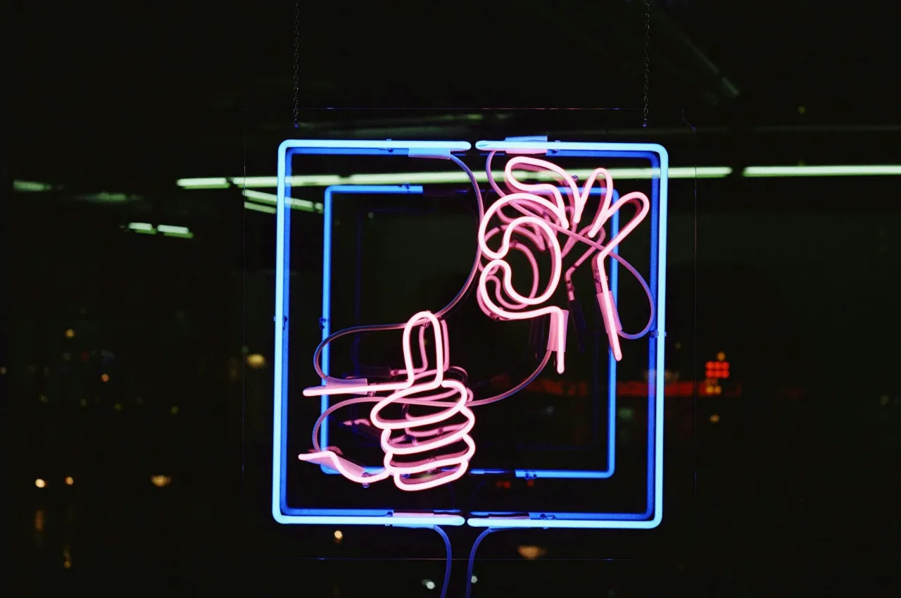 Neon thumbs-up sign — a nod to better, evidence-led decisions